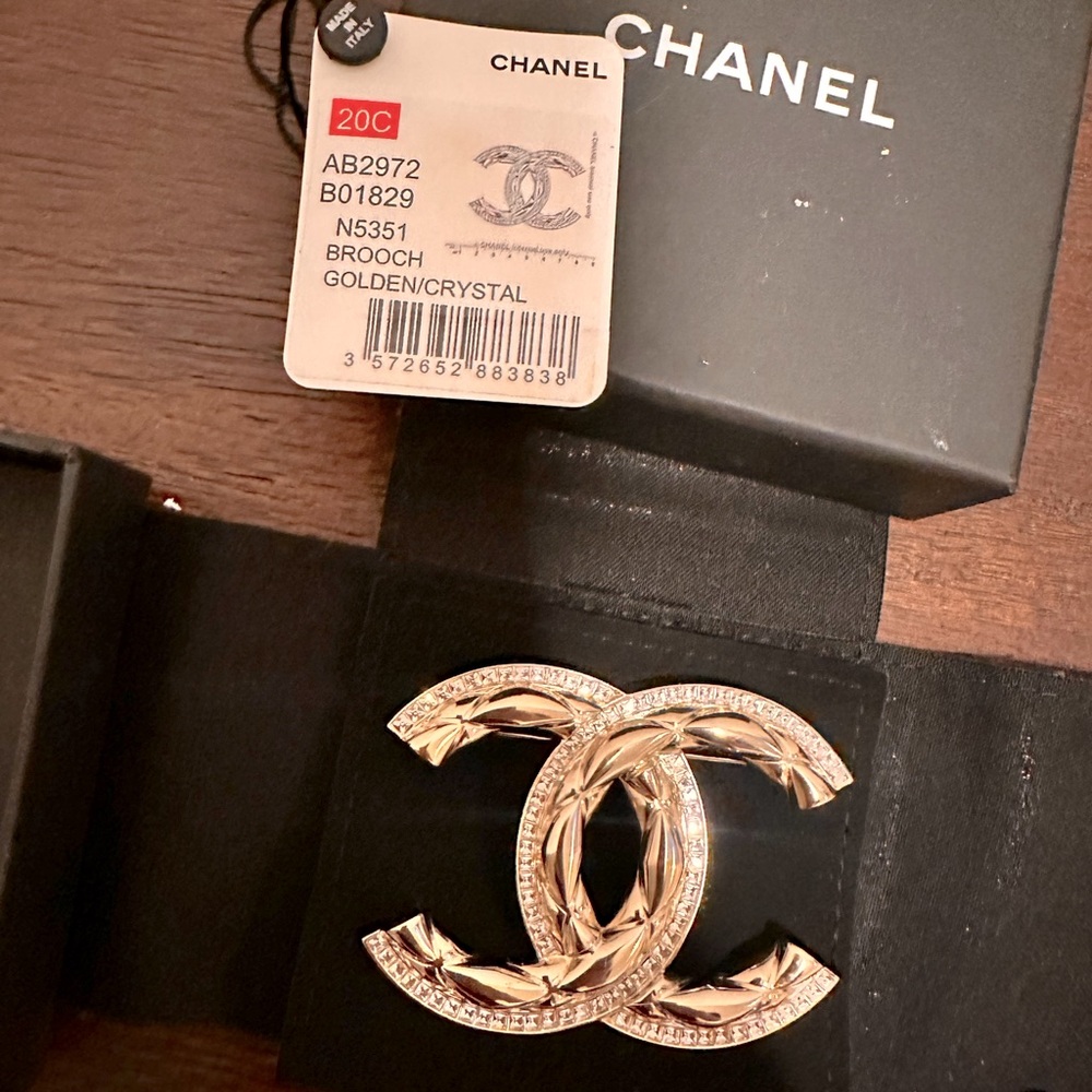 Chanel gold/diamond brooch. Used twice. With box and bag.